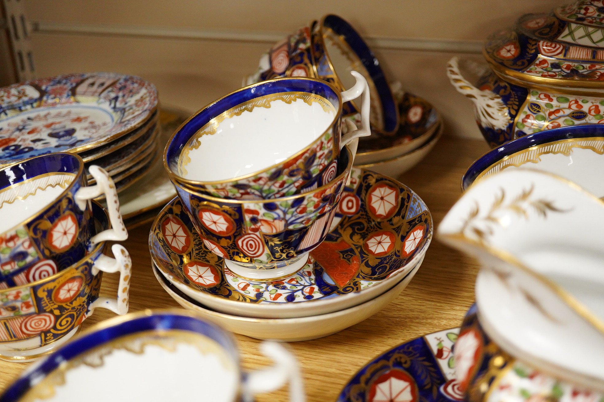 A 19th century Derby Imari pattern part tea set including a teapot a pair of 19th century botanical dishes and six small ironstone dishes.